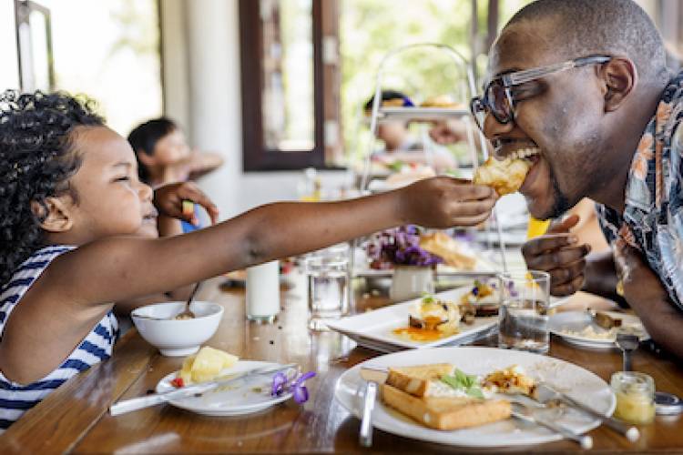 Father and daughter eating breakfast